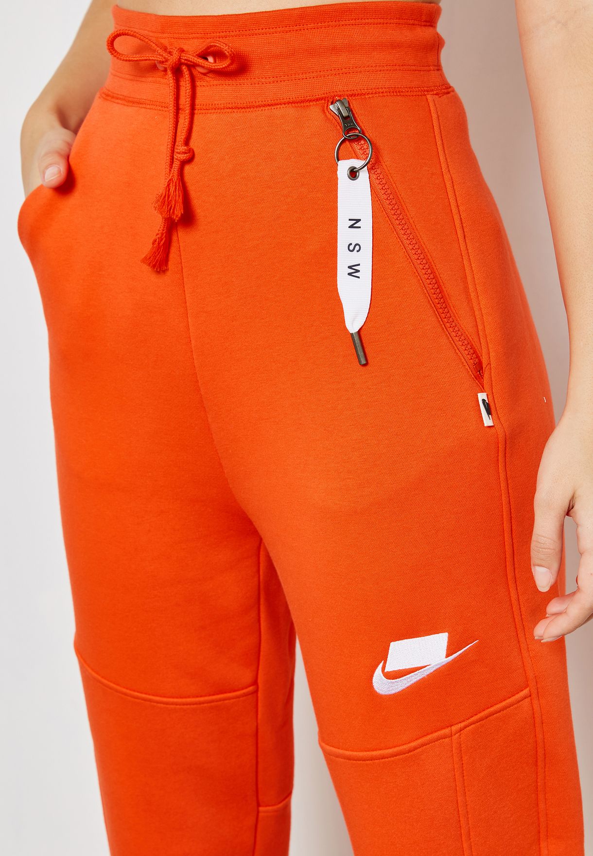 orange nike joggers womens