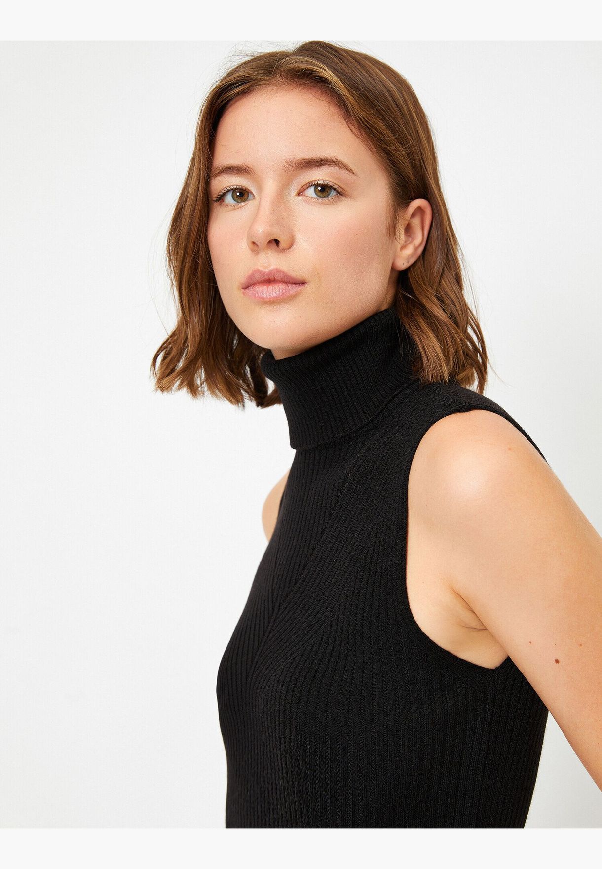 black turtleneck sleeveless sweater