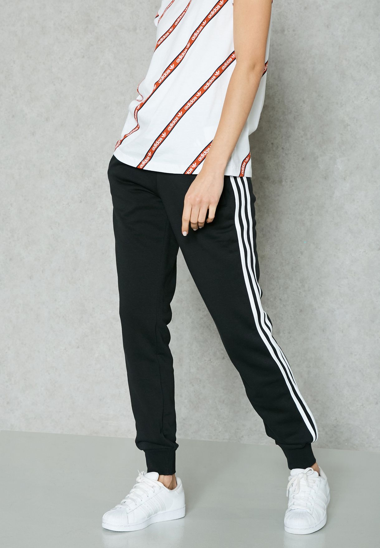 Buy adidas grey Essential Stripe Sweatpants Women in MENA,