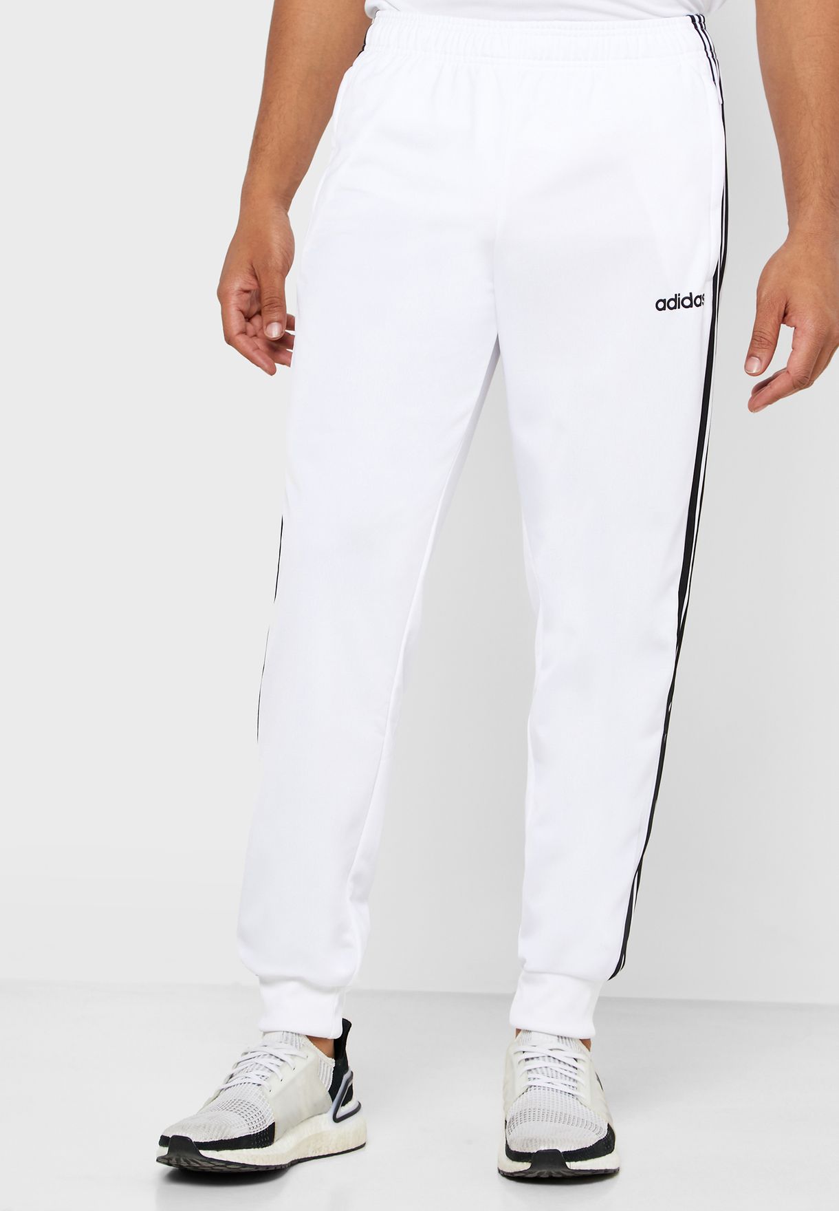 white adidas pants with white stripes