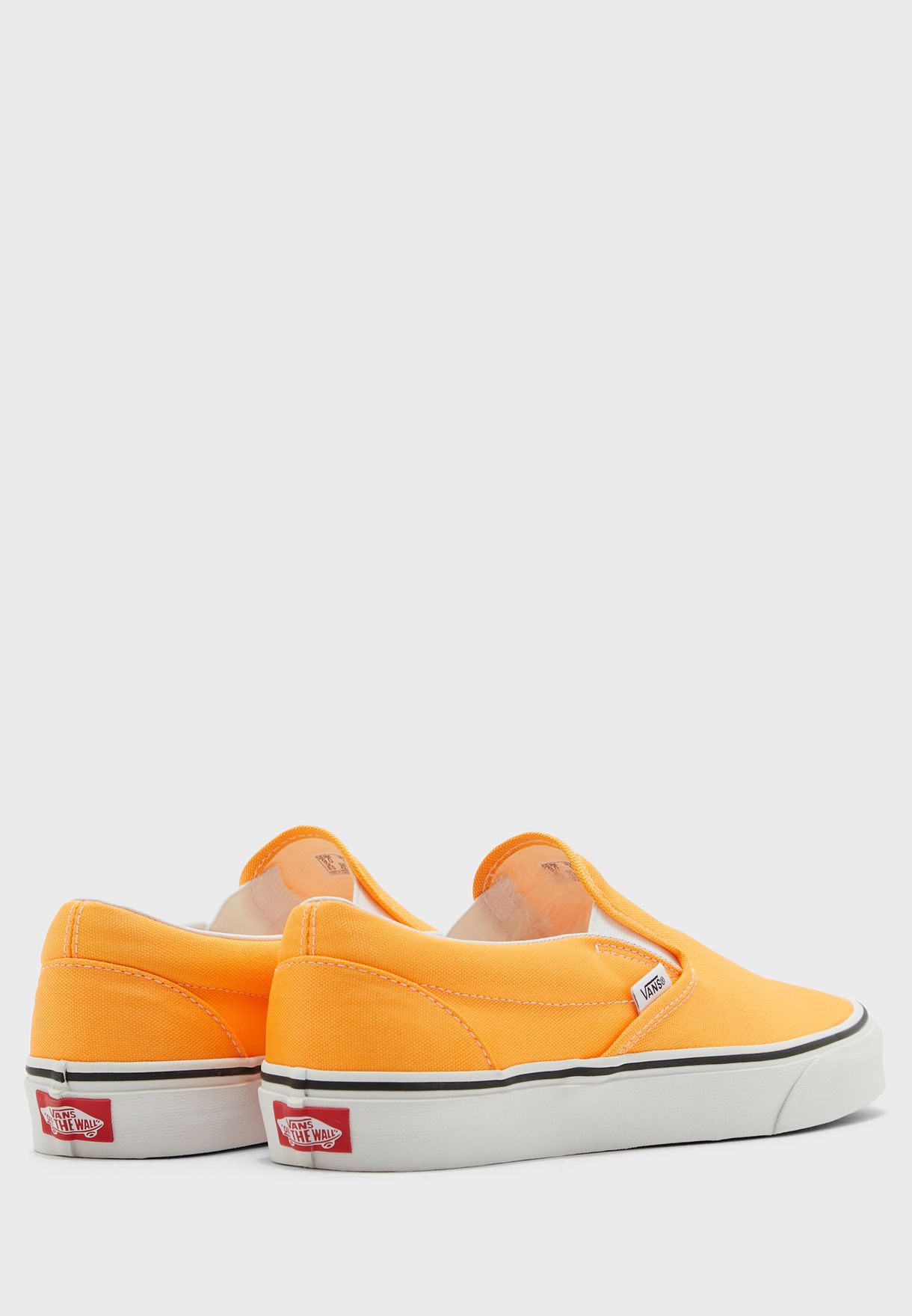 neon orange slip on vans