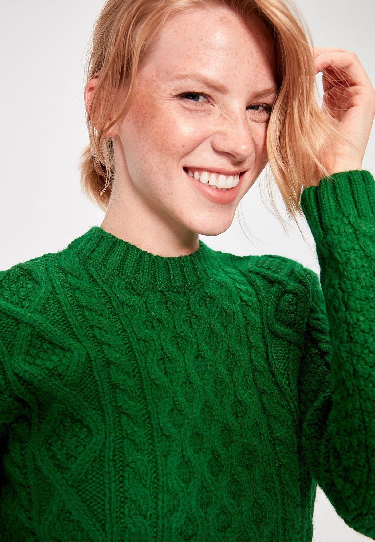 green cable knit sweater